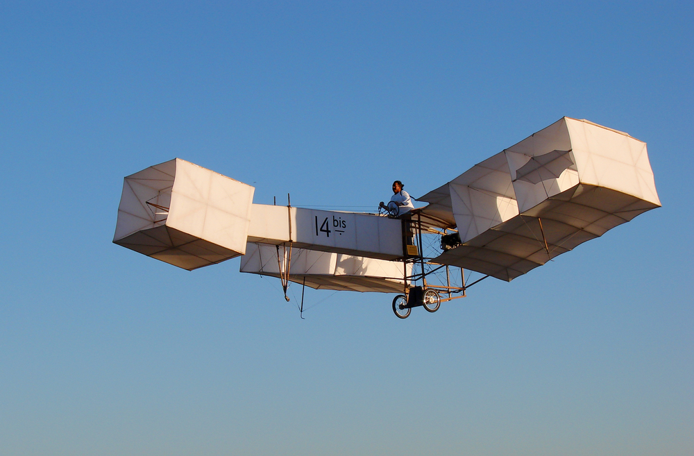 Early flight pioneers working on an aircraft
